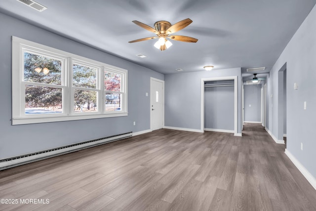 108 Manchester Ave, Forked River, NJ 08731 - interior space with visible vents, a ceiling fan, a baseboard heating unit, and wood finished floors