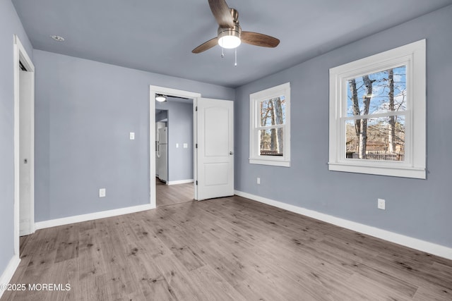 108 Manchester Ave, Forked River, NJ 08731 - unfurnished bedroom featuring baseboards, freestanding refrigerator, a ceiling fan, and wood finished floors