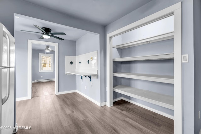 108 Manchester Ave, Forked River, NJ 08731 - interior space featuring baseboards, a ceiling fan, wood finished floors, and baseboard heating