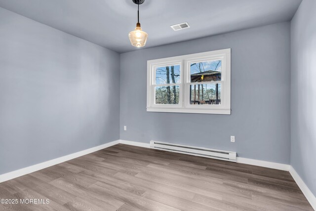 108 Manchester Ave, Forked River, NJ 08731 - empty room with visible vents, baseboards, wood finished floors, and baseboard heating