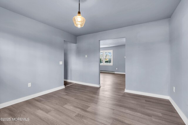 108 Manchester Ave, Forked River, NJ 08731 - spare room with baseboards, baseboard heating, and wood finished floors