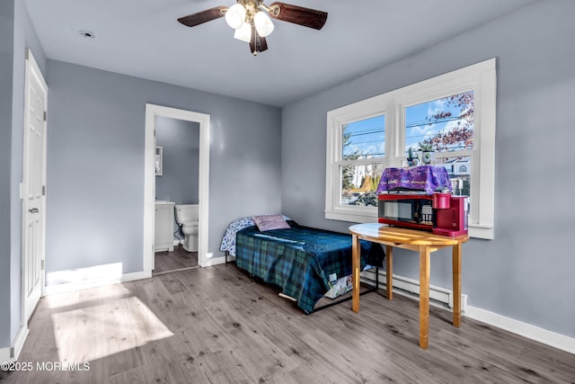 108 Manchester Ave, Forked River, NJ 08731 - bedroom featuring baseboards, a baseboard radiator, wood finished floors, and connected bathroom
