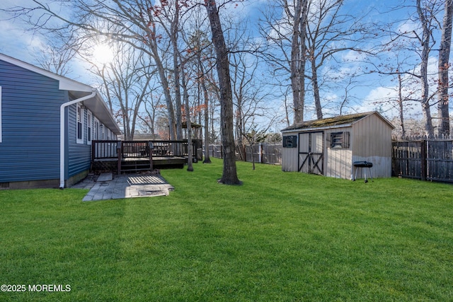 108 Manchester Ave, Forked River, NJ 08731 - view of yard with a storage unit, a fenced backyard, a wooden deck, and an outbuilding