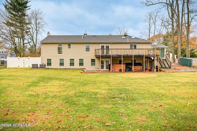 back of property with a deck, fence, a gate, and stairs