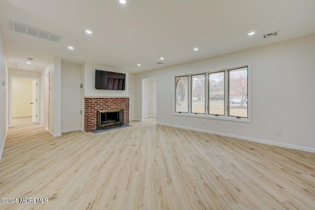 unfurnished living room featuring recessed lighting, visible vents, attic access, and light wood-type flooring