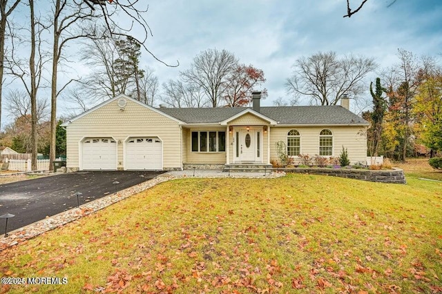 single story home with fence, an attached garage, a front lawn, aphalt driveway, and a chimney