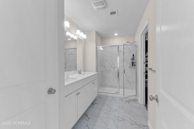 bathroom with visible vents, a marble finish shower, a sink, and marble finish floor
