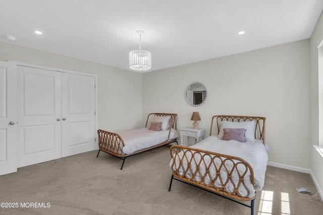 bedroom with carpet, a closet, recessed lighting, and a notable chandelier