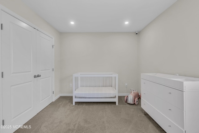 bedroom with baseboards, recessed lighting, and light colored carpet