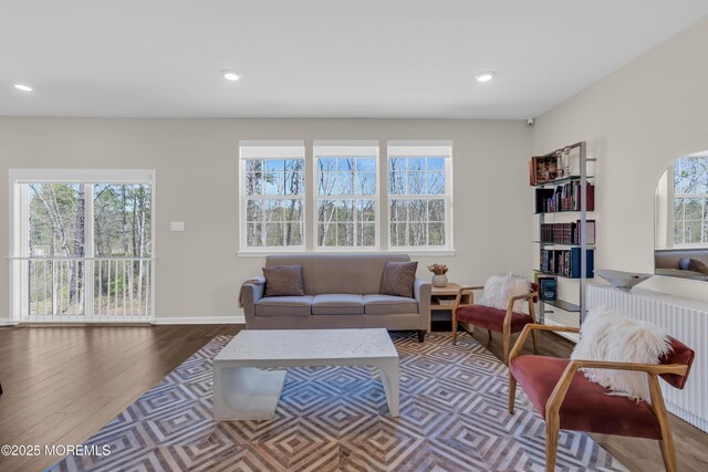 living room with recessed lighting, baseboards, wood finished floors, and radiator
