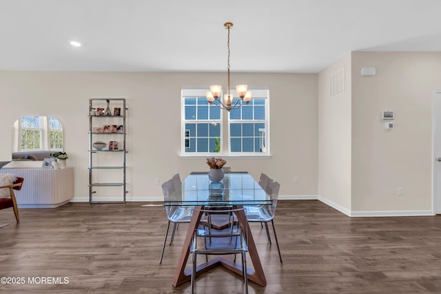 dining area with recessed lighting, baseboards, a notable chandelier, and wood finished floors
