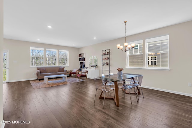 dining space with a chandelier, baseboards, dark wood finished floors, and recessed lighting