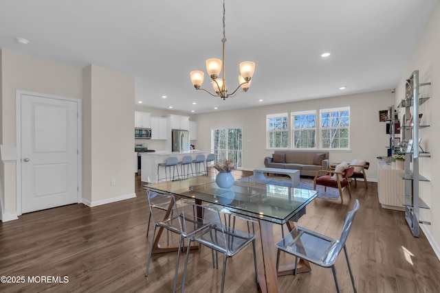 dining room with baseboards, recessed lighting, dark wood finished floors, and a notable chandelier