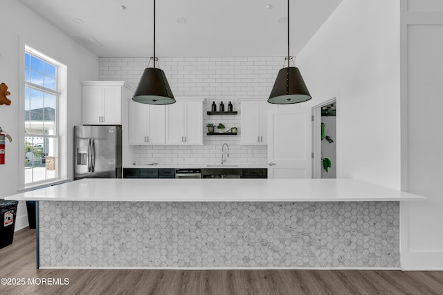 kitchen featuring a sink, light countertops, white cabinetry, and stainless steel appliances