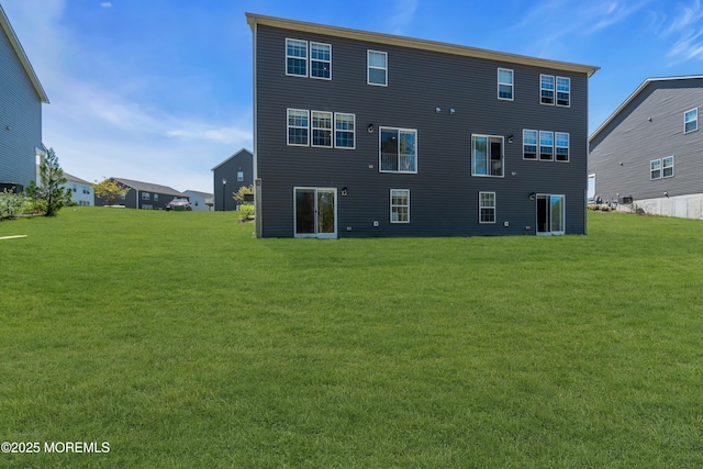 rear view of property with a yard