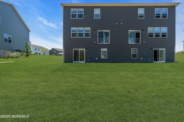 back of property featuring a yard