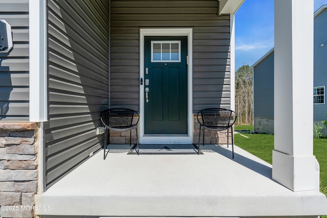 doorway to property with stone siding