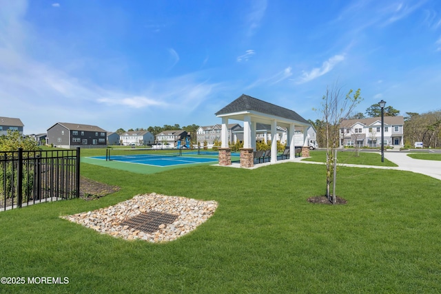 view of home's community featuring a yard, a gazebo, fence, and a residential view