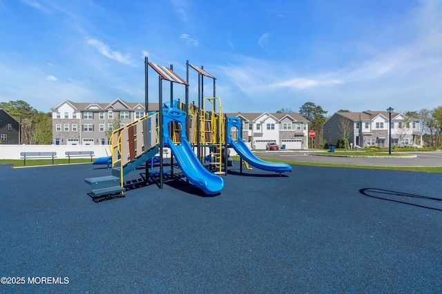 communal playground with fence and a residential view