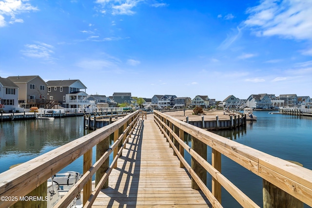dock area with a water view and a residential view