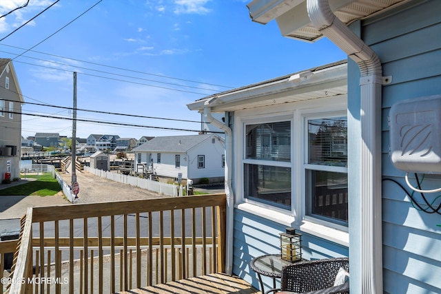deck with covered porch and a residential view