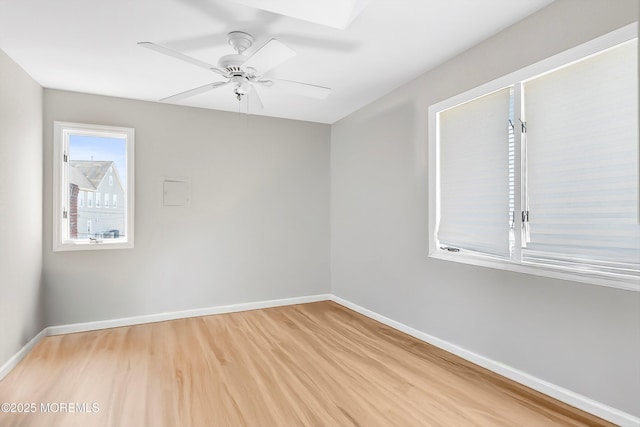 unfurnished room featuring baseboards, ceiling fan, and light wood-type flooring