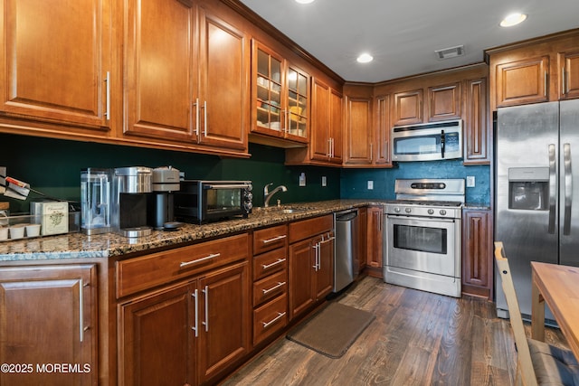 27 Mainbraid Ct, Tinton Falls, NJ 07753 - kitchen with visible vents, dark wood-style flooring, a sink, dark stone countertops, and stainless steel appliances