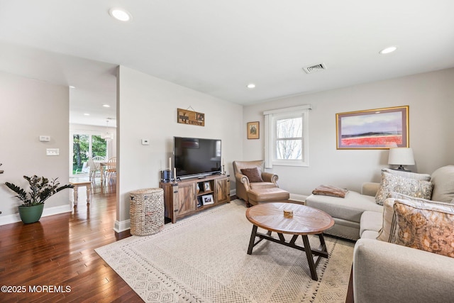 living area with visible vents, recessed lighting, baseboards, and wood finished floors