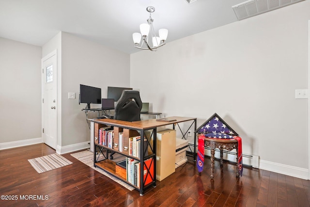 home office with baseboards, hardwood / wood-style flooring, and visible vents
