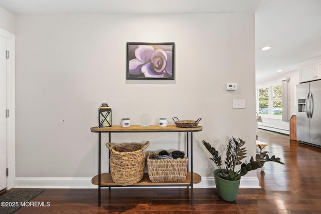 hallway featuring recessed lighting, baseboards, hardwood / wood-style flooring, and a baseboard radiator