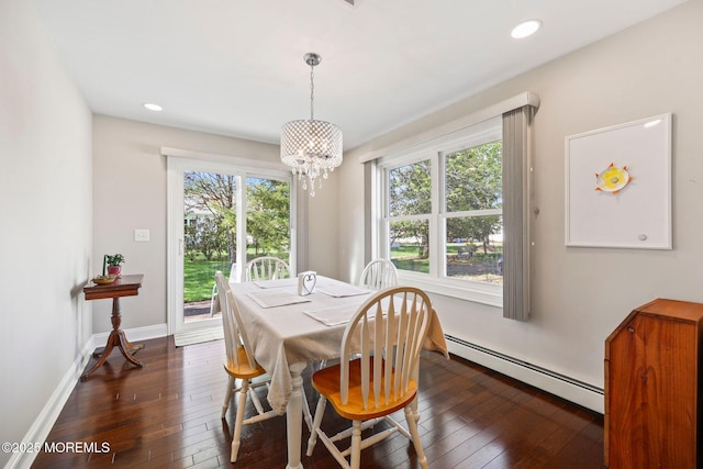 dining room with recessed lighting, a baseboard heating unit, dark wood-type flooring, and a chandelier