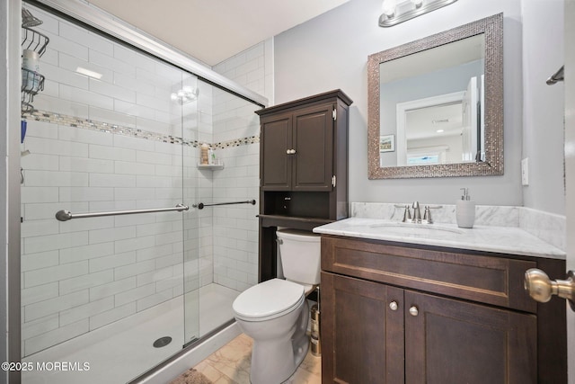 full bathroom featuring vanity, a shower stall, toilet, and marble finish floor