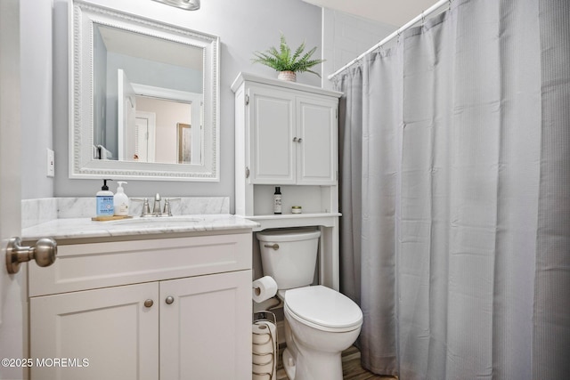 bathroom featuring vanity, a shower with shower curtain, and toilet