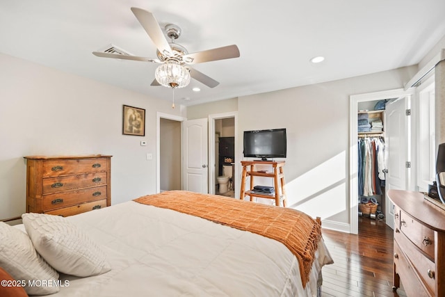 bedroom with recessed lighting, dark wood-style floors, a walk in closet, and a closet