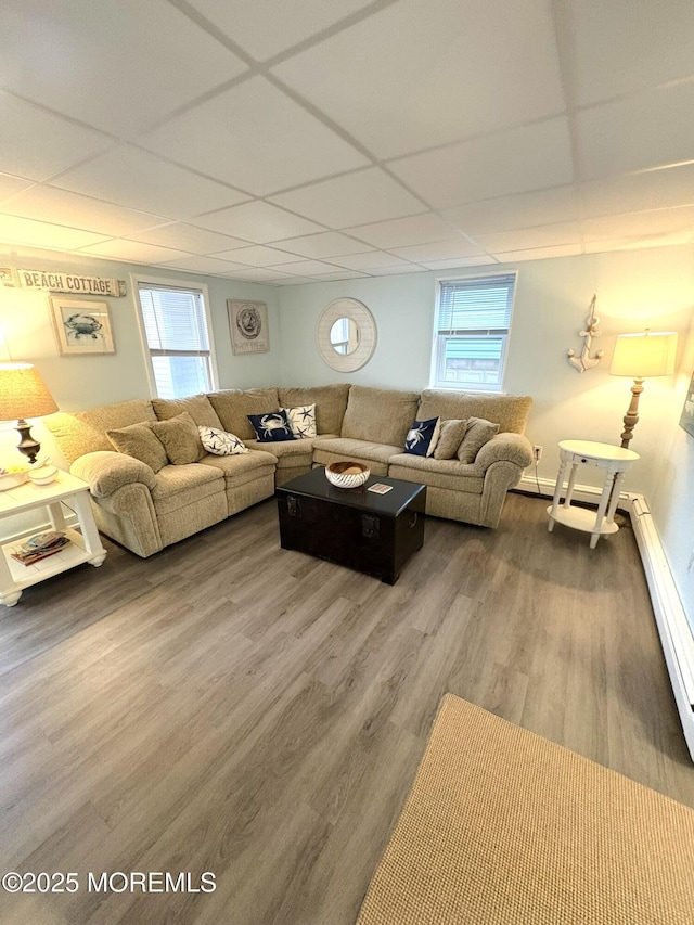 25 O St, Seaside Park, NJ 08752 - living room with a drop ceiling, wood finished floors, healthy amount of natural light, and a baseboard radiator