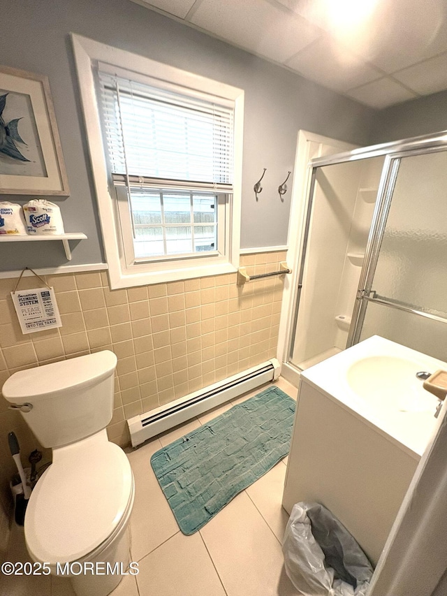 25 O St, Seaside Park, NJ 08752 - full bath featuring a baseboard radiator, tile walls, a stall shower, tile patterned floors, and vanity