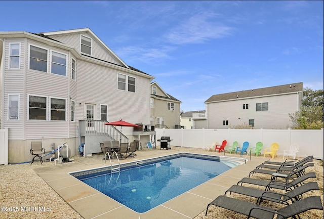 view of swimming pool with a fenced in pool, a patio area, fence, and a grill