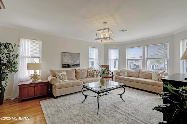 205 Arnold Ave, Point Pleasant Beach, NJ 08742 - living room with crown molding, light wood-style floors, and a chandelier