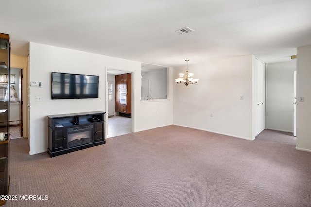 unfurnished living room featuring visible vents, carpet flooring, baseboards, and a chandelier