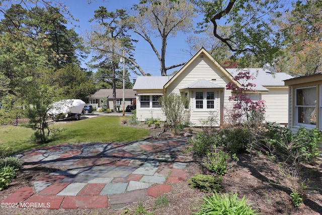 english style home with a front lawn