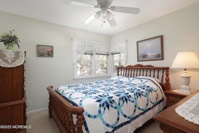 bedroom with a ceiling fan, baseboards, and light carpet
