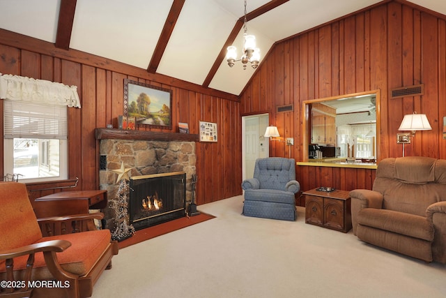 carpeted living room with wooden walls, visible vents, lofted ceiling, and a fireplace