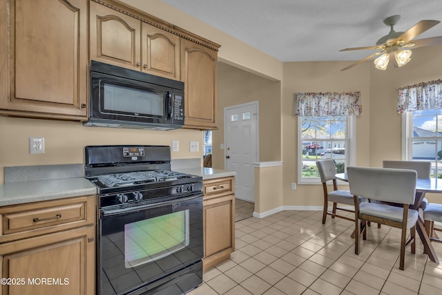 kitchen featuring light countertops, ceiling fan, black appliances, and a wealth of natural light