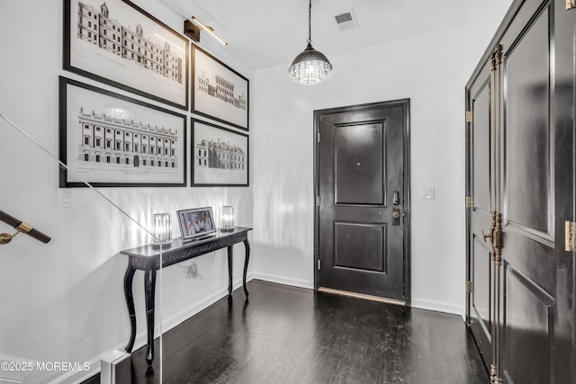 entryway with baseboards, visible vents, and dark wood-style floors