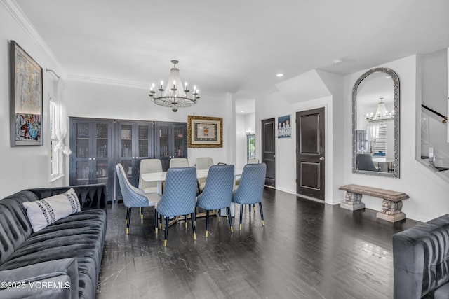dining room with crown molding, baseboards, an inviting chandelier, and wood finished floors
