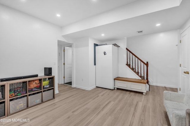 interior space featuring recessed lighting, baseboards, wood finished floors, and visible vents
