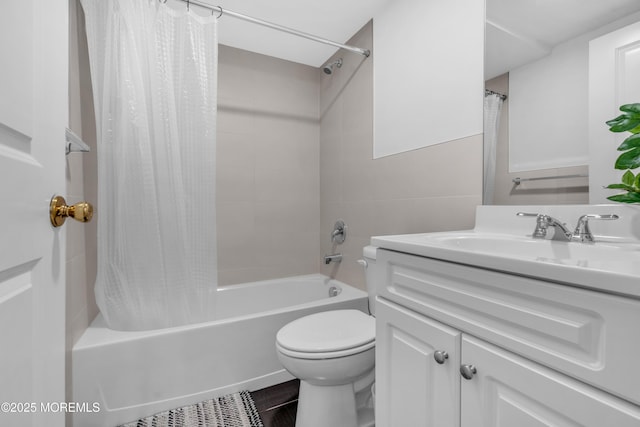 full bathroom featuring vanity, shower / bath combo with shower curtain, and toilet
