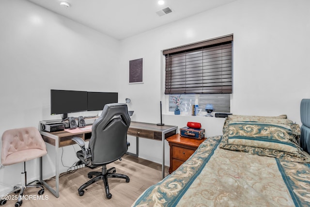 bedroom featuring visible vents and wood finished floors