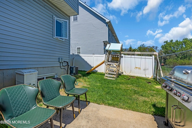 view of yard featuring a patio, a fenced backyard, a playground, and cooling unit