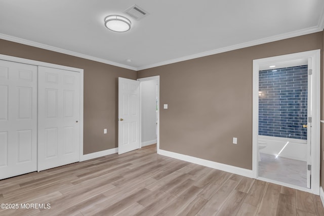 unfurnished bedroom featuring crown molding, visible vents, a closet, baseboards, and light wood-style flooring